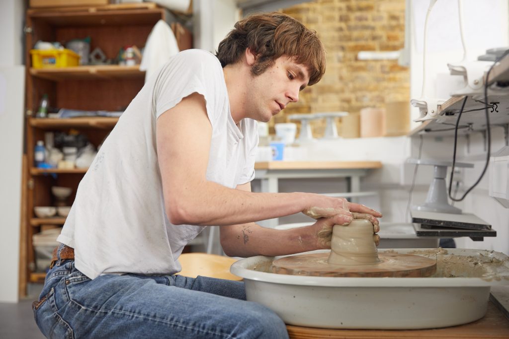 Student working on a pottery wheel 